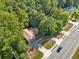 An aerial view of a single-Gathering home with mature trees, a large driveway and landscaping that adds to the curb appeal at 235 Shallowford Nw Rd, Kennesaw, GA 30144