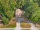 Aerial view of a house, driveway and surrounding lush trees at 235 Shallowford Nw Rd, Kennesaw, GA 30144