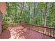 Inviting back deck surrounded by lush trees at 235 Shallowford Nw Rd, Kennesaw, GA 30144