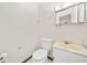 Bathroom with a toilet, sink and mirror at 235 Shallowford Nw Rd, Kennesaw, GA 30144
