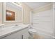 Bathroom with a tub and shower combination, updated vanity, and tile flooring at 235 Shallowford Nw Rd, Kennesaw, GA 30144