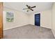Cozy bedroom with neutral colors, new carpet, ceiling fan and large window, for a relaxing and comfortable space at 235 Shallowford Nw Rd, Kennesaw, GA 30144