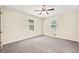 Bedroom features a ceiling fan, two windows, neutral paint, and plush carpeting at 235 Shallowford Nw Rd, Kennesaw, GA 30144