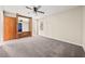 Spacious bedroom features a ceiling fan, neutral paint, and plush carpeting at 235 Shallowford Nw Rd, Kennesaw, GA 30144