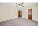 Bedroom featuring a ceiling fan, neutral paint, carpet, and wooden doors at 235 Shallowford Nw Rd, Kennesaw, GA 30144
