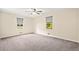 Bedroom features neutral paint, plush carpeting, and two windows for natural light at 235 Shallowford Nw Rd, Kennesaw, GA 30144
