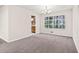 Bright dining room with neutral colors and new carpet, next to a large window and access to kitchen at 235 Shallowford Nw Rd, Kennesaw, GA 30144