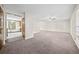 Bright entryway, with views to living room and dining room featuring neutral colors and new carpet at 235 Shallowford Nw Rd, Kennesaw, GA 30144