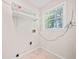 Functional laundry room with shelving and natural light at 235 Shallowford Nw Rd, Kennesaw, GA 30144
