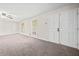 Bright living room with new carpet, ceiling fan, and double doors leading to backyard at 235 Shallowford Nw Rd, Kennesaw, GA 30144