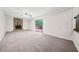 Living room with a stone fireplace, sliding glass doors, and plush carpeting at 235 Shallowford Nw Rd, Kennesaw, GA 30144