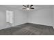 Spacious bedroom with plush carpeting, ceiling fan, and neutral paint, ready for personalization at 3945 Hamilton Cove Ct, Cumming, GA 30028