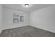 Bright bedroom features plush carpeting, a window with blinds, and neutral paint at 3945 Hamilton Cove Ct, Cumming, GA 30028