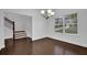 Elegant dining room features hardwood floors, staircase, and a window offering ample natural light at 3945 Hamilton Cove Ct, Cumming, GA 30028
