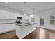Bright kitchen featuring white cabinets, granite countertops, and stainless steel appliances at 3945 Hamilton Cove Ct, Cumming, GA 30028