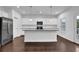 Gourmet kitchen featuring white cabinets, granite countertops, stainless steel appliances, and a large island at 3945 Hamilton Cove Ct, Cumming, GA 30028