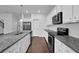 Kitchen featuring granite countertops, white cabinets, and stainless steel appliances at 3945 Hamilton Cove Ct, Cumming, GA 30028