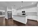 Modern kitchen boasts stainless steel appliances, a center island, and an open concept design at 3945 Hamilton Cove Ct, Cumming, GA 30028