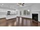 Open concept living room with fireplace, hardwood floors, and ample natural light at 3945 Hamilton Cove Ct, Cumming, GA 30028