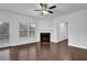 Spacious living room featuring a fireplace, hardwood floors, and a door to the outdoor living space at 3945 Hamilton Cove Ct, Cumming, GA 30028