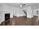 Bright and airy living room featuring hardwood floors, a fireplace, and an open floor plan at 3945 Hamilton Cove Ct, Cumming, GA 30028