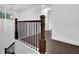 Staircase with wooden railings and black metal balusters at 3945 Hamilton Cove Ct, Cumming, GA 30028