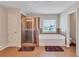 Bathroom featuring a glass-enclosed shower and a separate soaking tub at 1606 Kenilworth Se Ln, Conyers, GA 30013