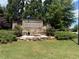 Landscaped entrance sign for Summit Creek with stone accents and flower detail at 1606 Kenilworth Se Ln, Conyers, GA 30013