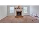 Cozy living room featuring a stone fireplace and neutral carpet at 1606 Kenilworth Se Ln, Conyers, GA 30013