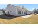 Back of house with a patio, well-maintained lawn, and mature trees in the background at 1056 Fern Valley Way, Dacula, GA 30019