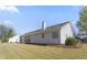 Back of house with a patio, well-maintained lawn, and mature trees in the background at 1056 Fern Valley Way, Dacula, GA 30019