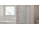 Bathroom with a tub, a standing shower, and lots of natural light at 1056 Fern Valley Way, Dacula, GA 30019