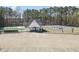 Community center features a pool, tennis court, and parking area surrounded by trees at 1056 Fern Valley Way, Dacula, GA 30019