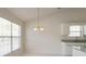 Bright dining area features a chandelier, large windows, and modern gray countertops at 1056 Fern Valley Way, Dacula, GA 30019