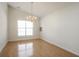 Charming dining area with gleaming hardwood floors and a decorative chandelier at 1056 Fern Valley Way, Dacula, GA 30019