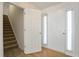 Bright foyer features hardwood floors, staircase, and a white front door with sidelight windows at 1056 Fern Valley Way, Dacula, GA 30019
