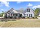 Charming single-story home boasts a well-manicured lawn and inviting curb appeal with classic design elements at 1056 Fern Valley Way, Dacula, GA 30019