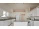 Well-lit kitchen with white cabinetry, granite countertops, stainless steel appliances, and an island at 1056 Fern Valley Way, Dacula, GA 30019