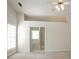 Main bedroom leads to bathroom and features a vaulted ceiling and bright window at 1056 Fern Valley Way, Dacula, GA 30019