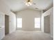 Spacious main bedroom with vaulted ceiling, neutral carpet and ample closet space at 1056 Fern Valley Way, Dacula, GA 30019