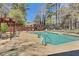 Community pool with lounge chairs and outdoor seating surrounded by tall trees at 1281 Branch Dr, Tucker, GA 30084
