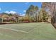 Outdoor community tennis court surrounded by trees under a bright blue sky at 1281 Branch Dr, Tucker, GA 30084
