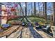 Gorgeous backyard with stone patio, lush landscaping, mature trees, and outdoor seating area at 1287 University Ne Dr, Atlanta, GA 30306