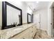 Bright bathroom featuring double sinks, granite countertops, and framed mirrors at 1287 University Ne Dr, Atlanta, GA 30306