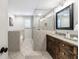 Bathroom featuring tiled shower, soaking tub, and wooden vanity at 1287 University Ne Dr, Atlanta, GA 30306