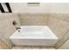 Bathroom displaying white soaking tub with stone tile surround at 1287 University Ne Dr, Atlanta, GA 30306