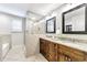 Bathroom showcasing glass-enclosed shower and dark wood double vanity with granite countertops at 1287 University Ne Dr, Atlanta, GA 30306