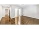 A bedroom featuring beautiful wood floors and doorways to adjacent rooms at 1287 University Ne Dr, Atlanta, GA 30306