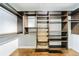 Walk-in closet with custom shelving, dark wood finish, and ample storage space at 1287 University Ne Dr, Atlanta, GA 30306