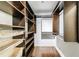 A walk-in closet with dark wood shelving, hanging rods, and drawers at 1287 University Ne Dr, Atlanta, GA 30306